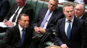 Tony Abbott looks on as Christopher Pyne, with whom he clashed earlier in the day over same-sex marriage, addresses question time.